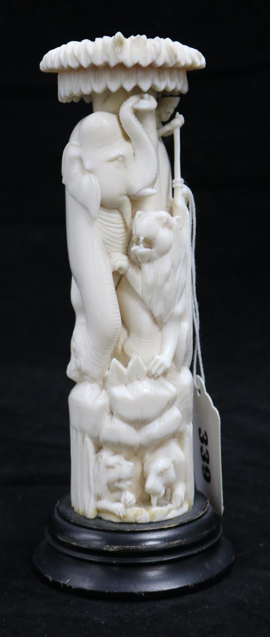 An African ivory carving of a lion and elephant, c.1930, overall 20cm